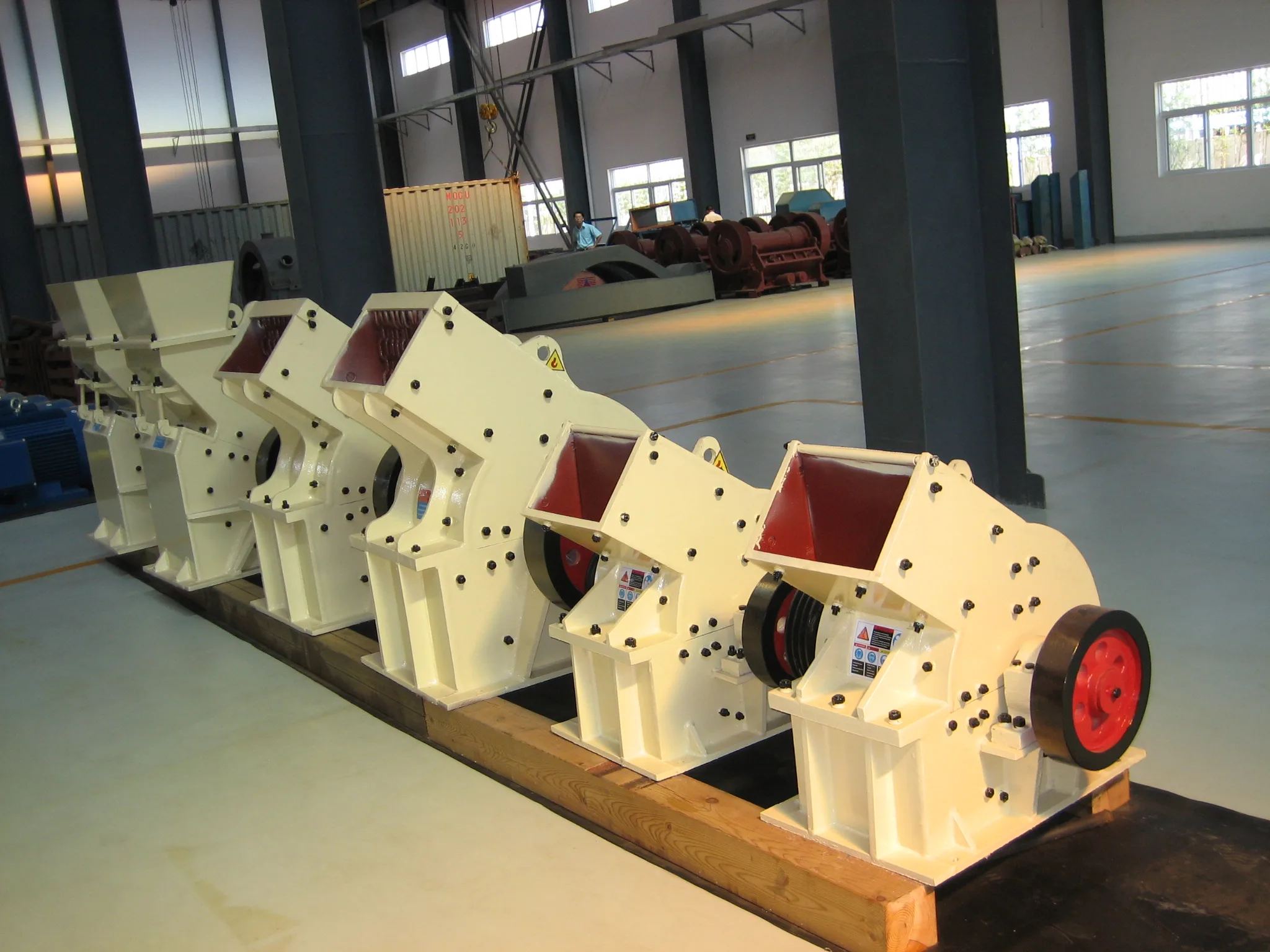 Cronus PC series hammer crushers lined up inside the manufacturing workshop